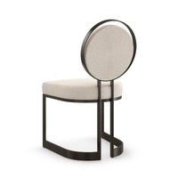 Modern dining chair showcasing backrest and base design.