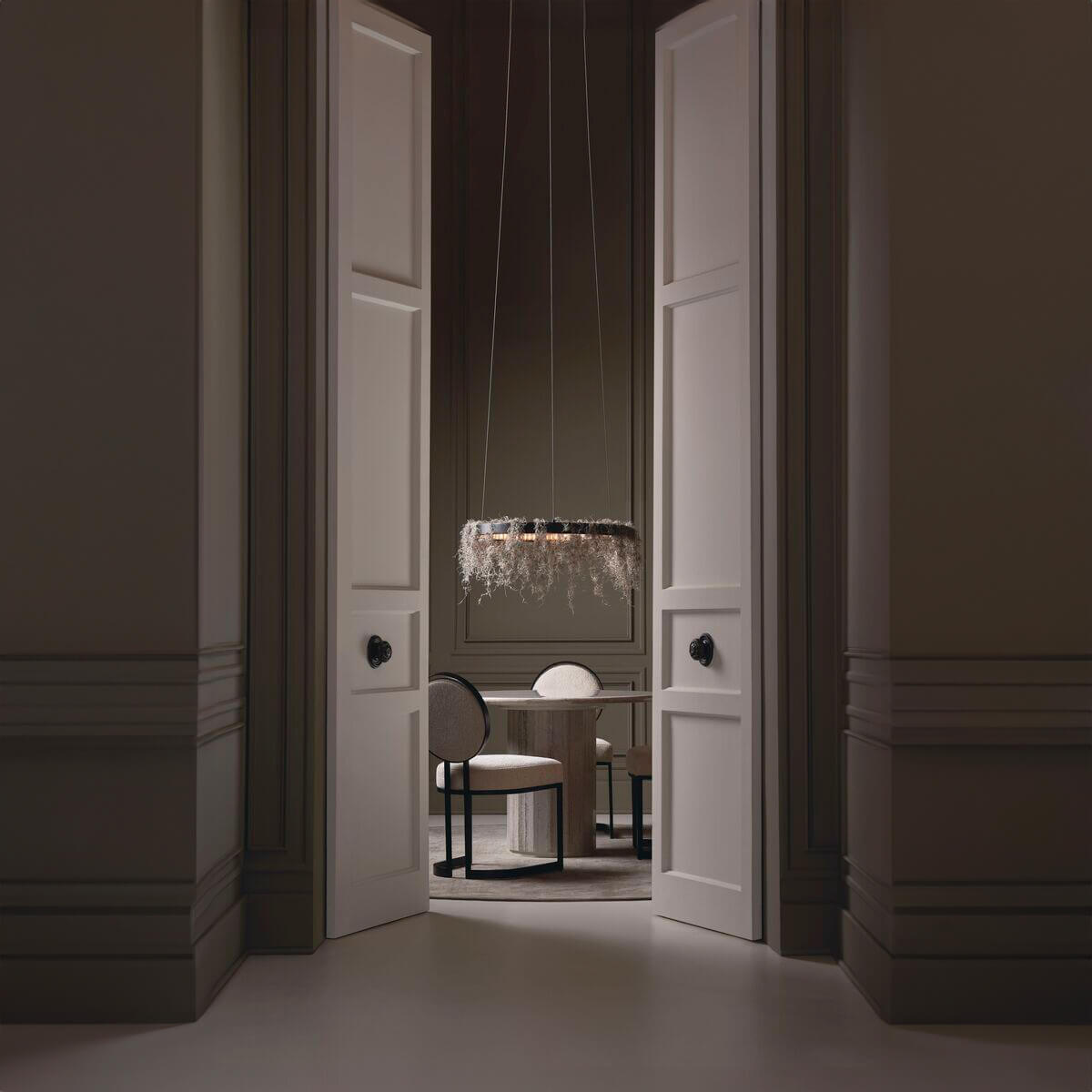 Elegant dining room with modern chairs and pendant light.