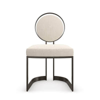 Modern dining chair with rounded back, front view.
