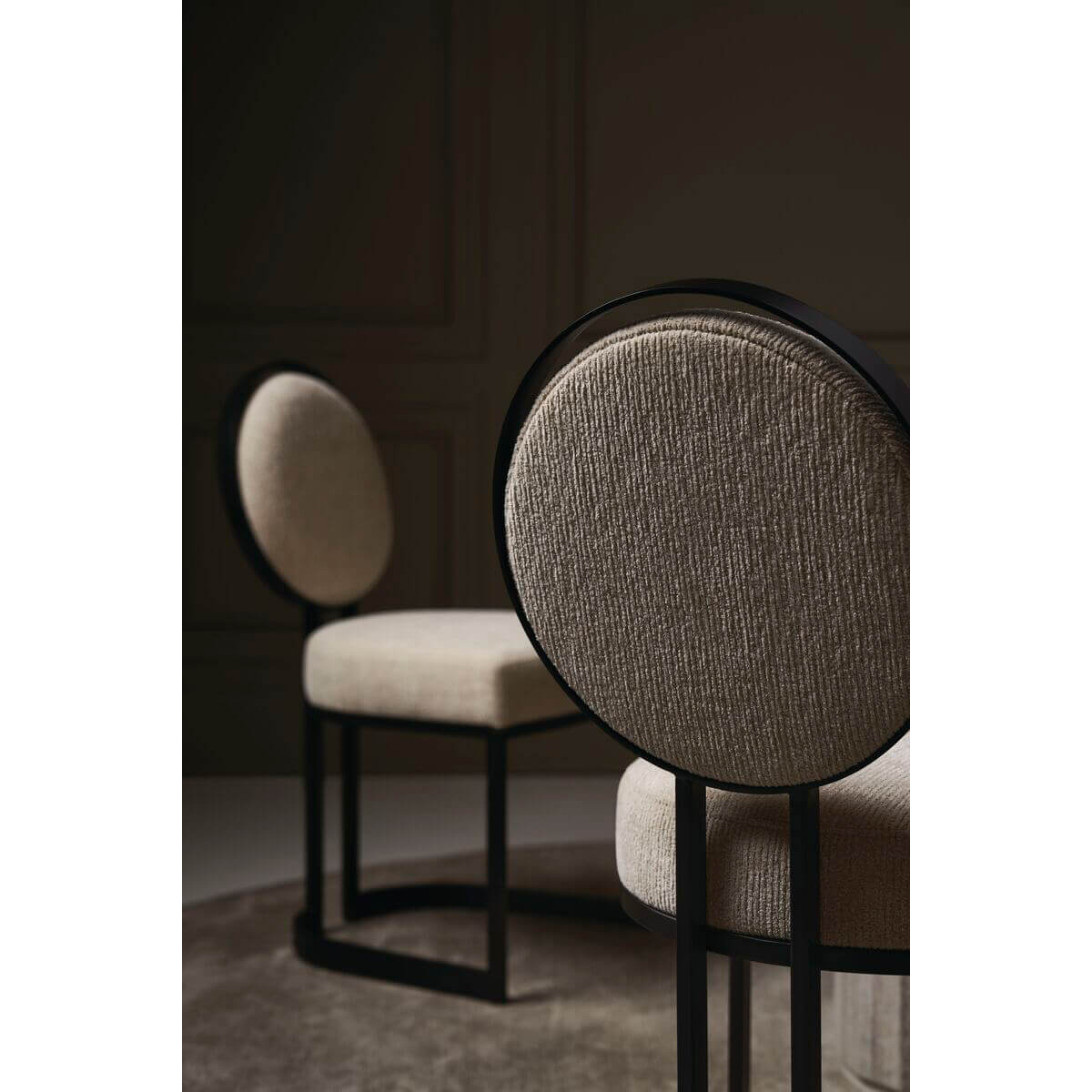 Pair of modern dining chairs in stylish interior setting.