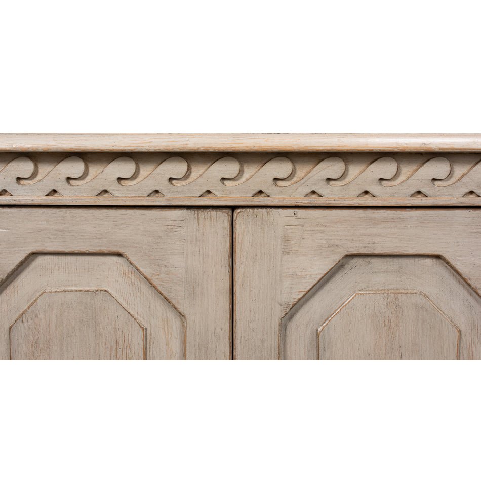Close-up of ornate trim on credenza front.