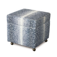 Closed storage ottoman cube with navy animal print fabric.