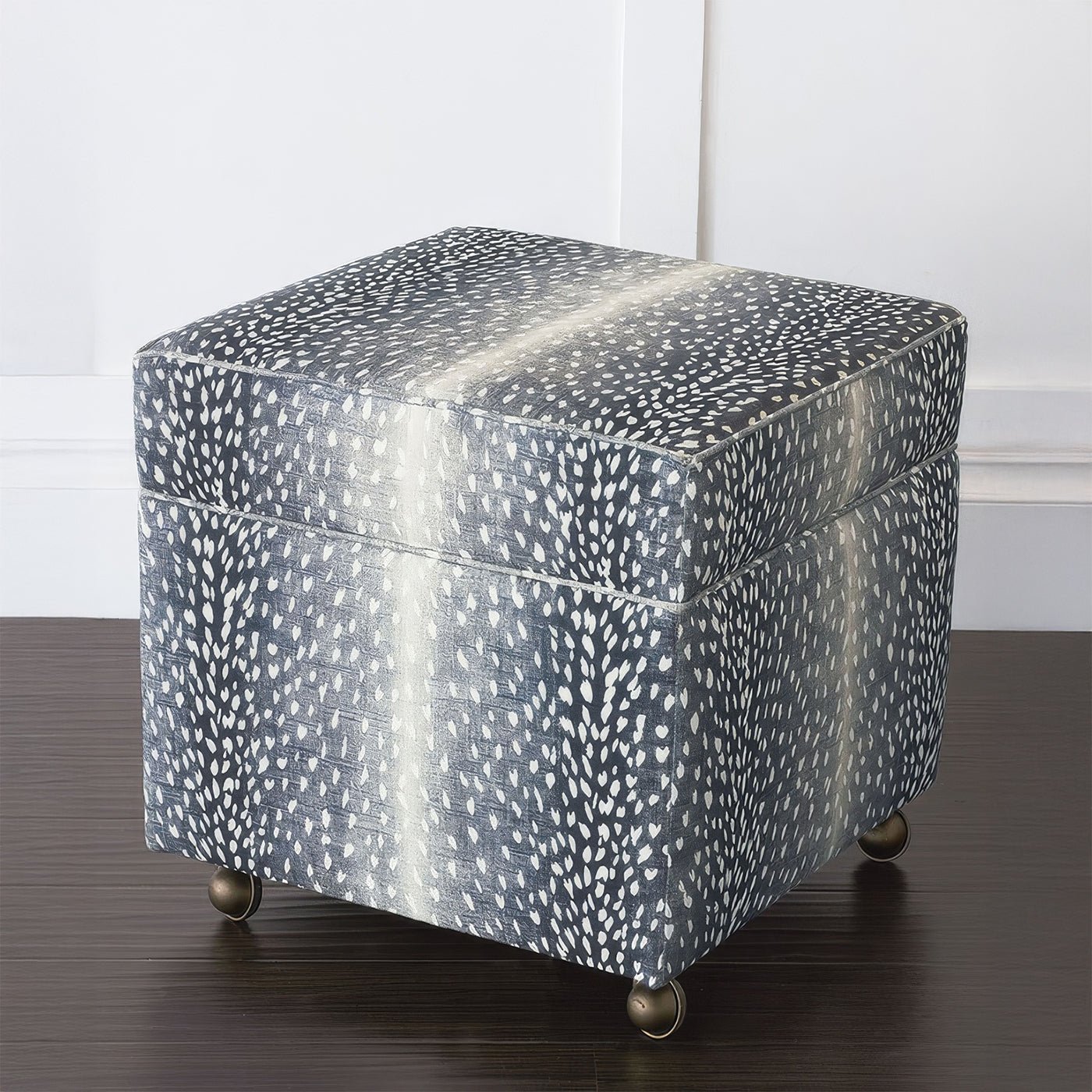 Closed storage ottoman cube on wooden floor.