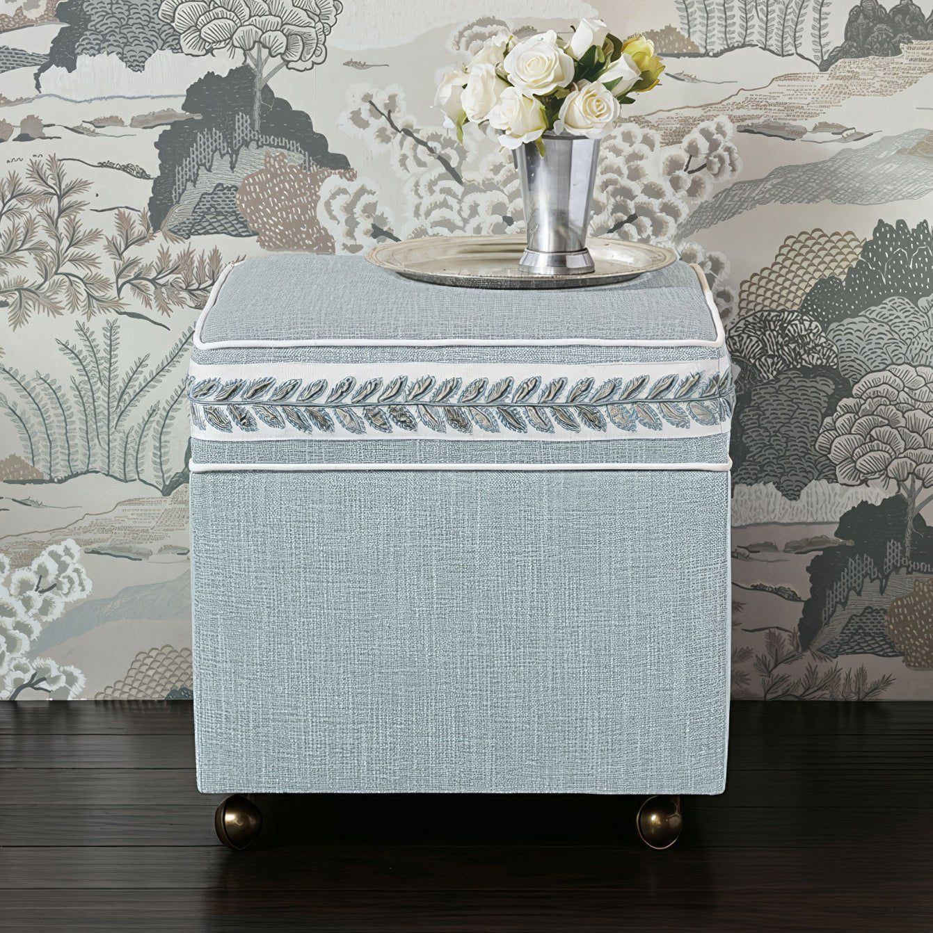 Sky blue ottoman cube with flowers atop in decor.