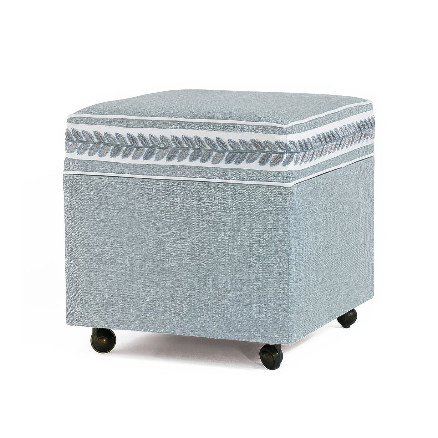 Sky blue ottoman cube with decorative leaf pattern.