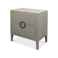 Gray nightstand with gold trim and circular handle.