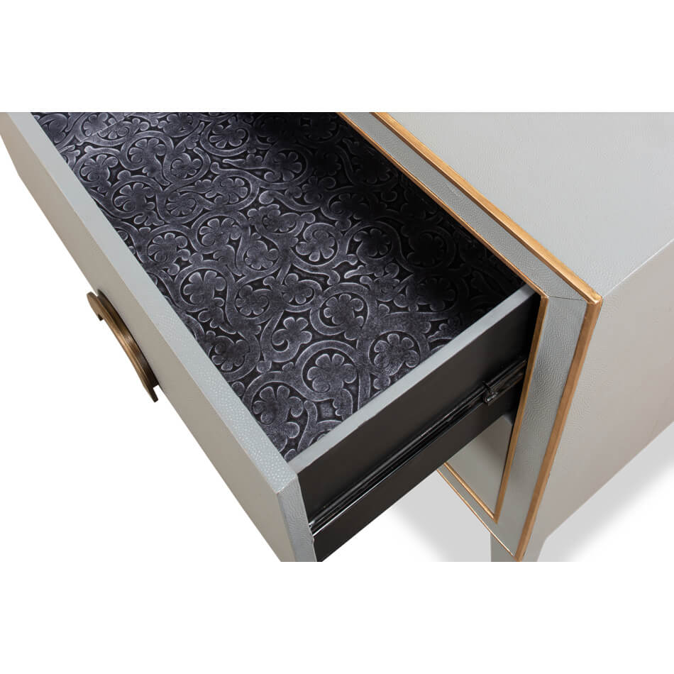 Open drawer of gray nightstand with patterned interior.