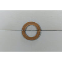 Close-up of circular handle on gray nightstand.