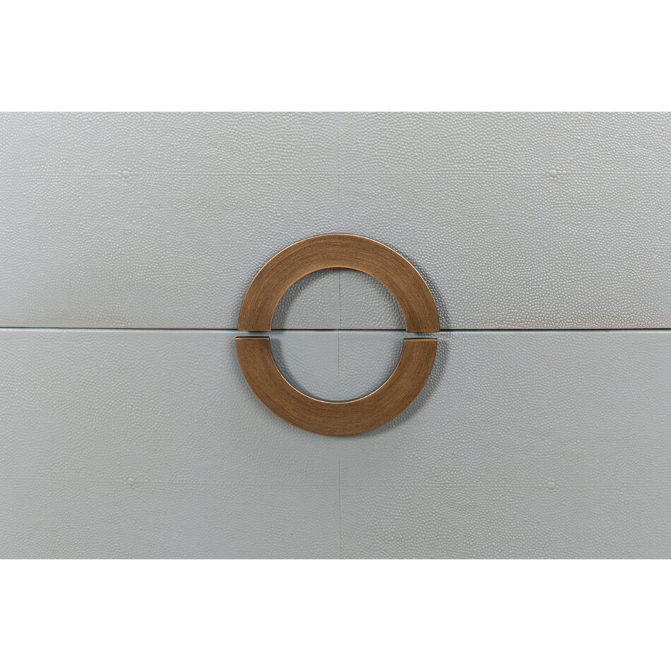 Close-up of circular handle on gray nightstand.