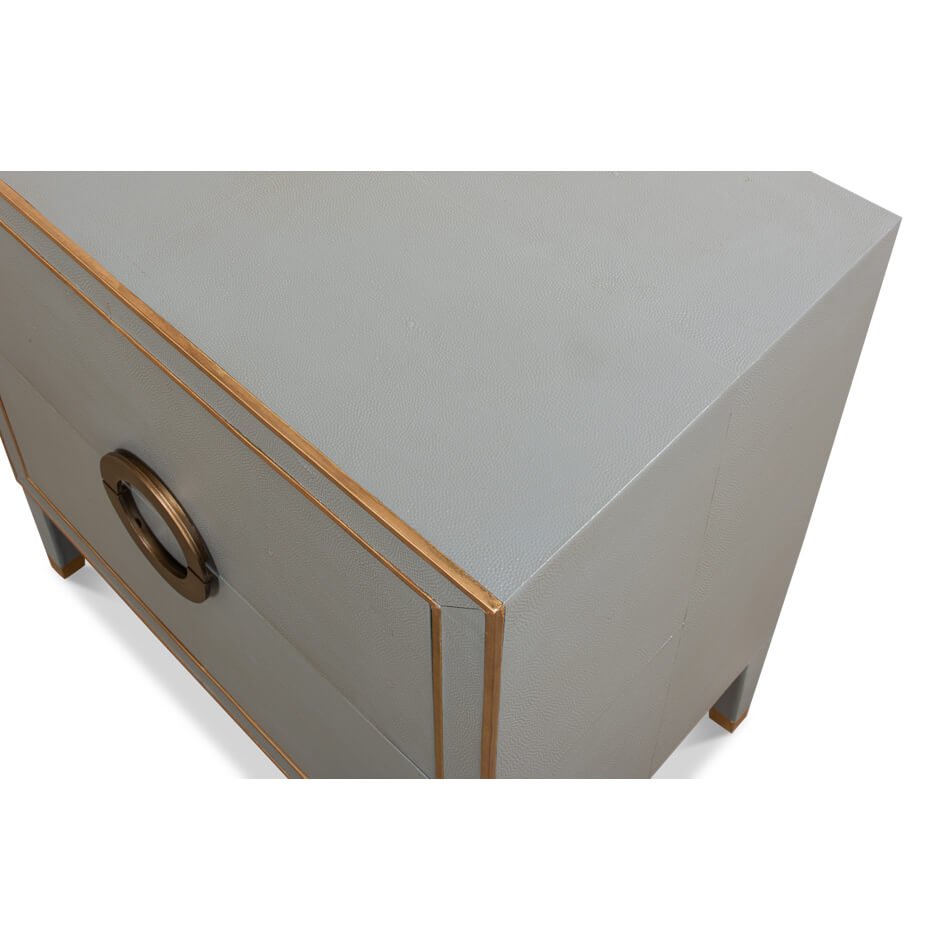 Angled top corner of gray nightstand with accents.