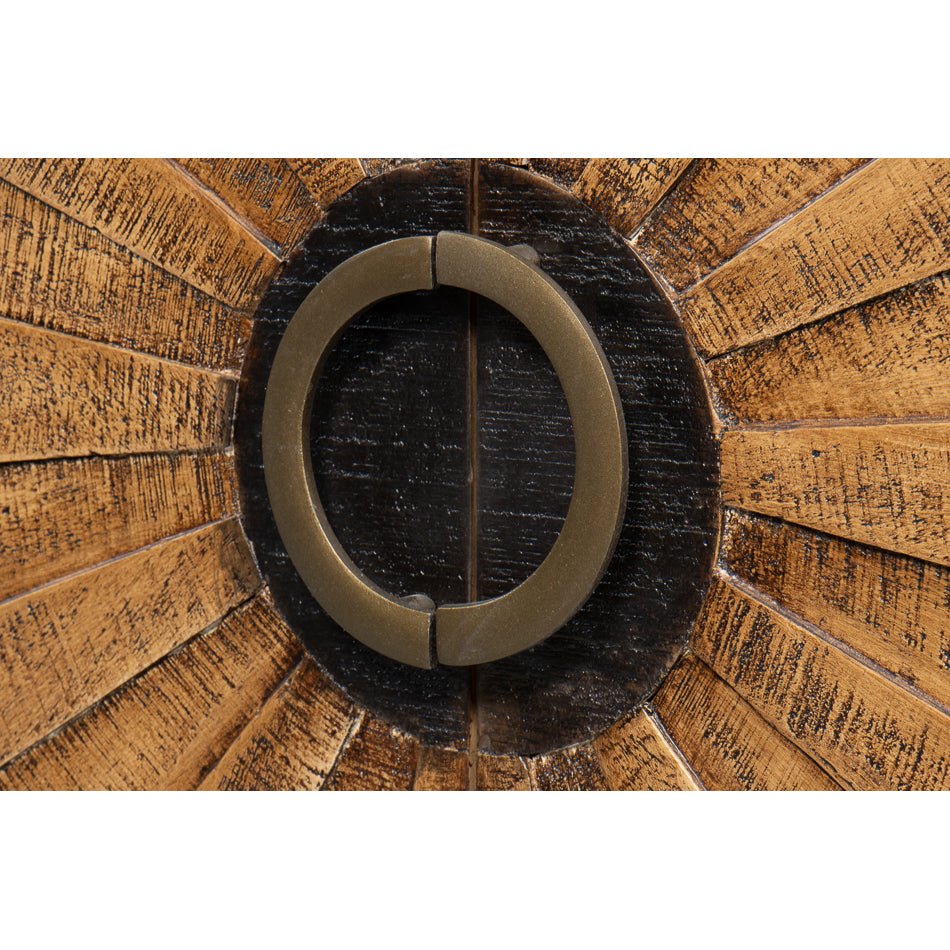 Close-up of circular handle on sunburst wood cabinet.