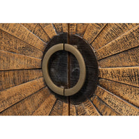 Close-up of circular handle on wood sideboard.
