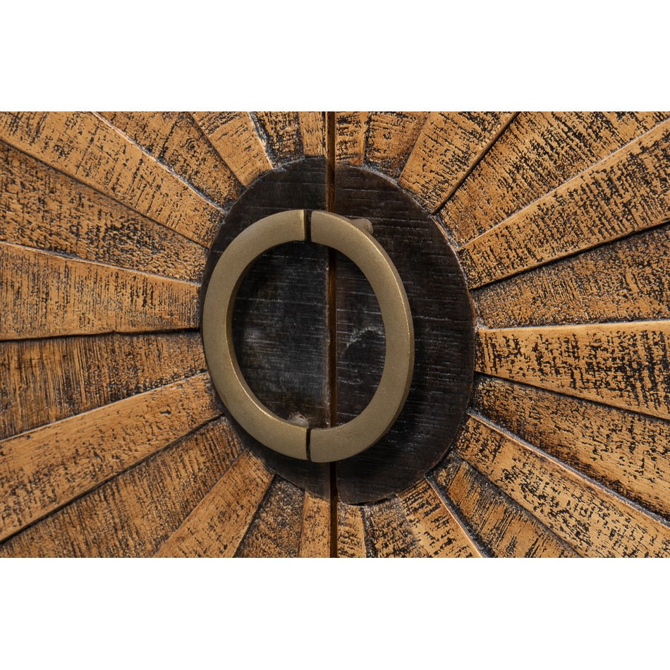 Close-up of circular handle on wood sideboard.