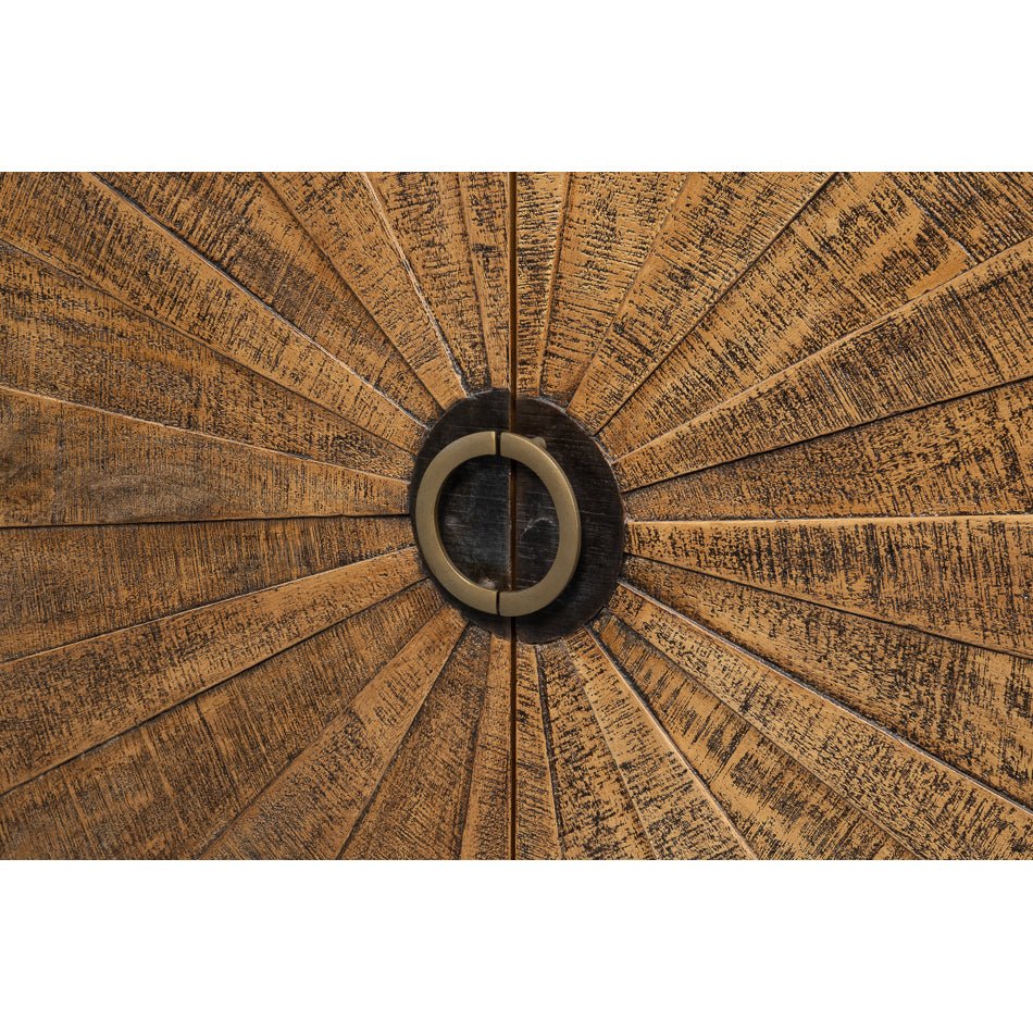 Detailed view of sunburst door design on sideboard.