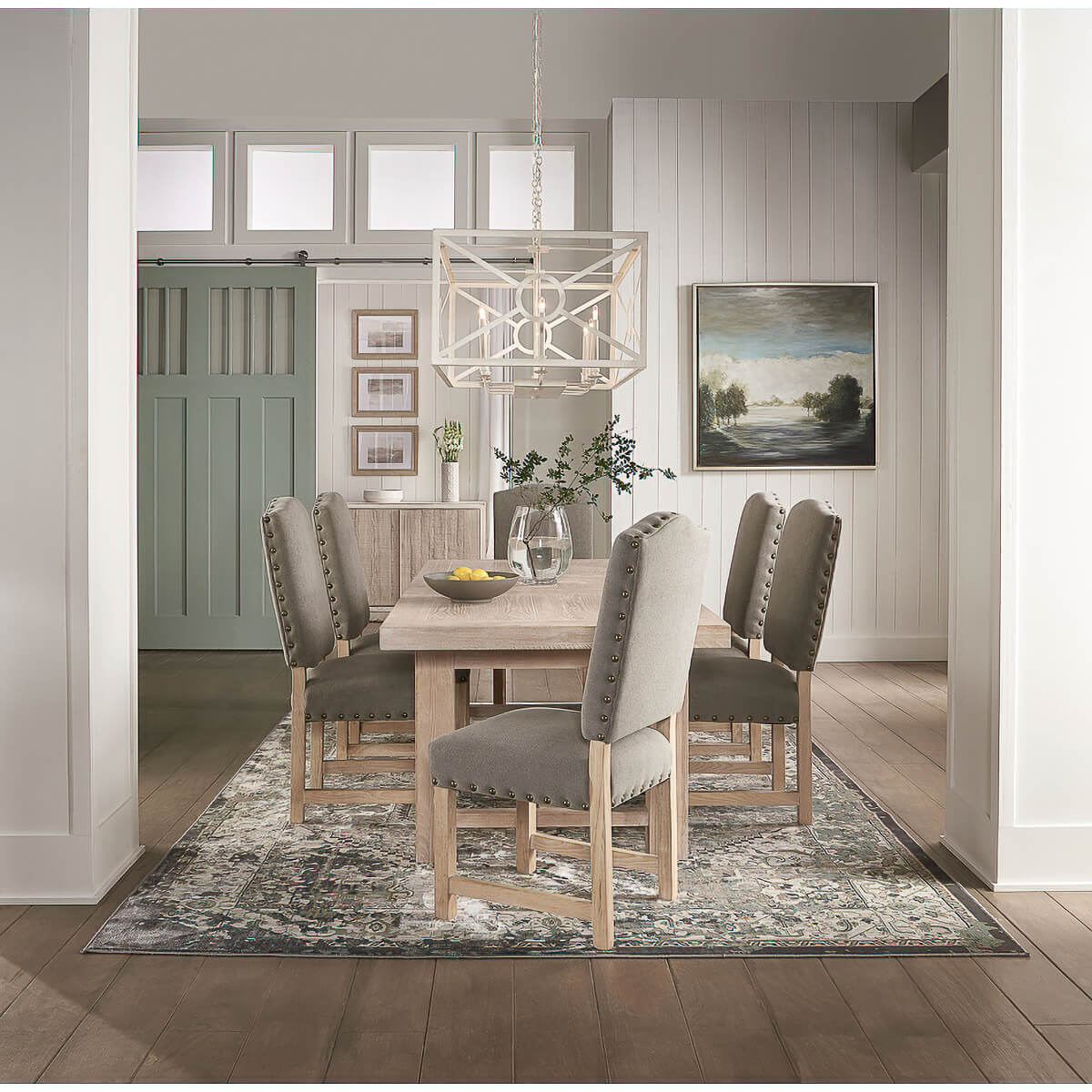 Dining table in dining room, styled with chairs and rug.
