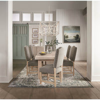 Dining table in dining room, styled with chairs and rug.