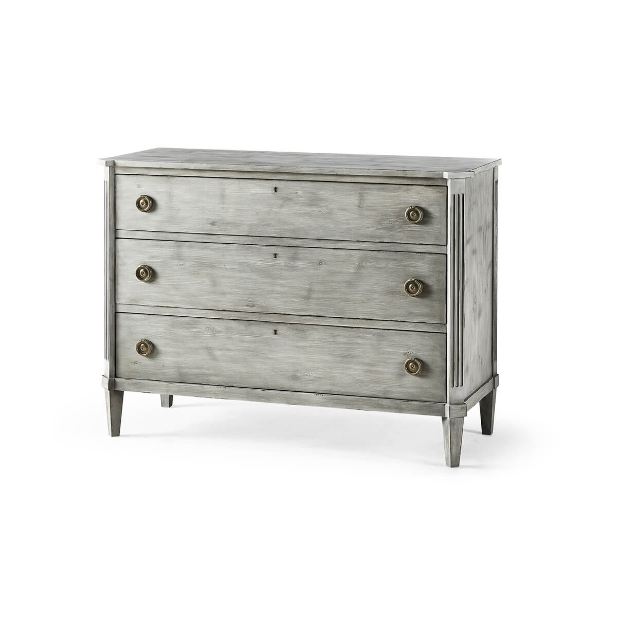 Antiqued grey Swedish commode, three-quarter view, three drawers.