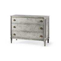 Antiqued grey Swedish commode, three-quarter view, three drawers.