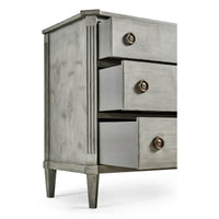 Open drawers of grey Swedish commode, side angle.