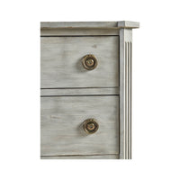 Close-up of Swedish commode drawer knobs, grey finish.