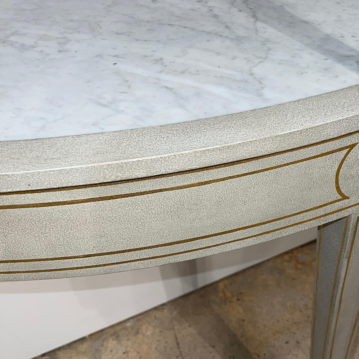 Marble top and painted detailing on console table.