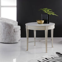 Round side table styled in a modern living room.