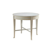 Round side table with light finish and gold accents.
