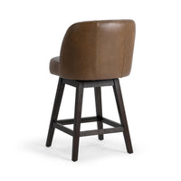 Three-quarter rear view of the brown leather swivel counter stool showing its smooth curved back and dark wood legs