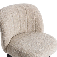 Close-up of the textured cream seat and channel-stitched curved back