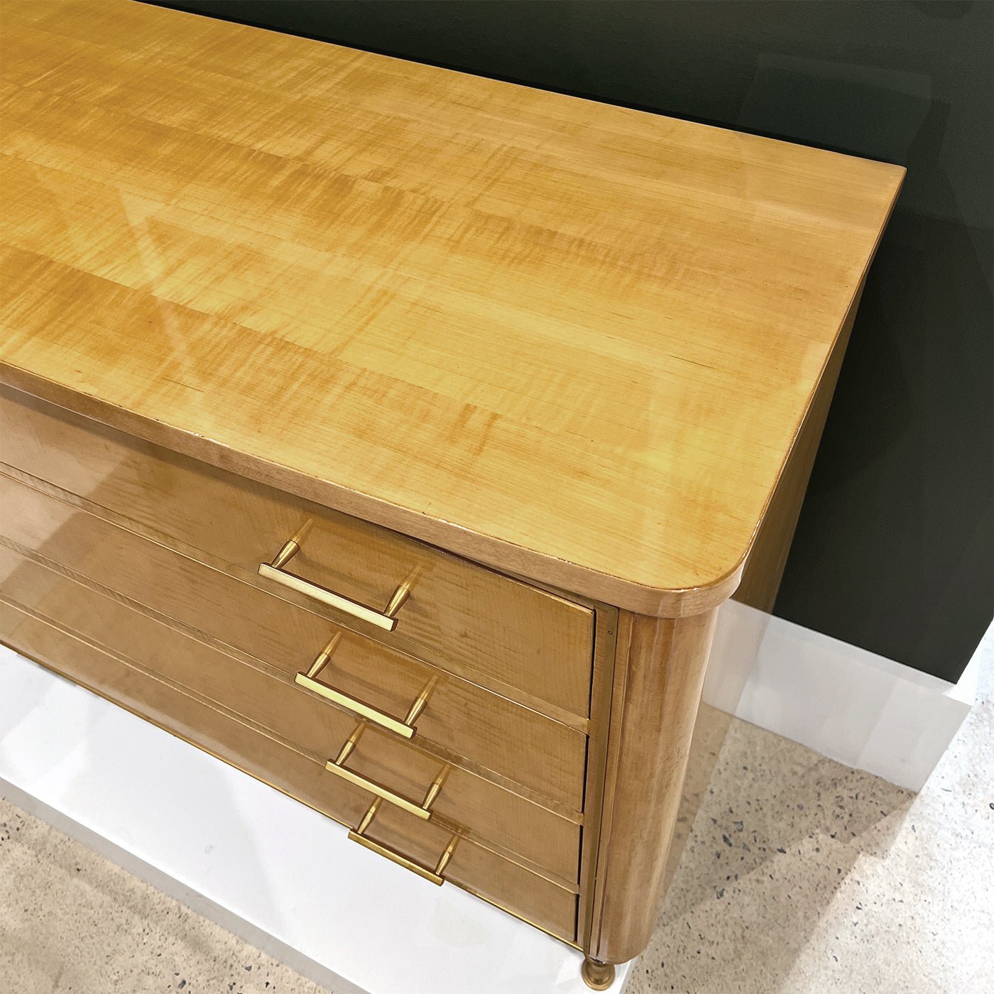 Top view of polished sycamore chest surface.