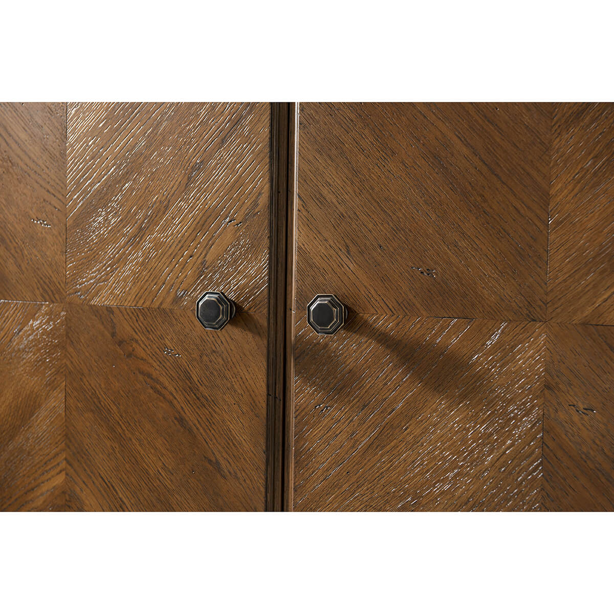 Cabinet door close-up with dark knobs and wood texture.