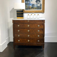 Tall Empire chest, marble topped, with lamp and artwork.