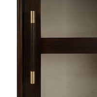 Close-up of display cabinet handle, gold and wood design.