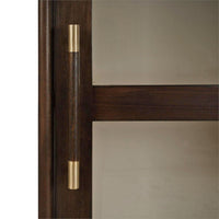 Detailed close-up of cabinet door handle and glass.