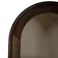 Close-up of cabinet arched top detail, wood finish.