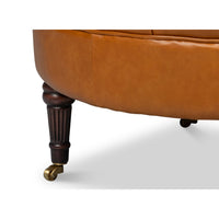 Chair front leg detail, wood with caster wheel.