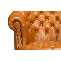 Close-up, chair armrest detail with nailhead trim.