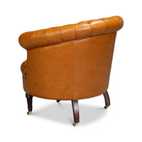 Tan leather barrel chair, rear-left angle view.