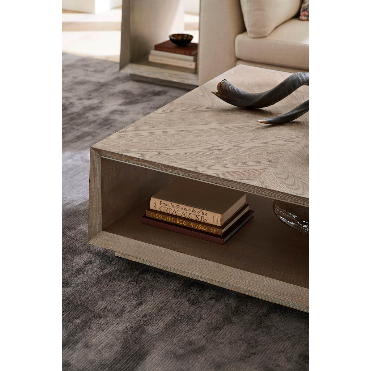 Tapered ash coffee table, books and decor underneath.