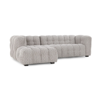 Angled front view of gray two-piece chaise sectional with channeled cushions and rounded arms