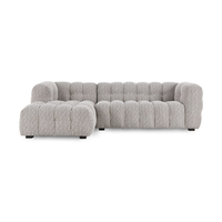 Front view of gray textured sectional showing the long chaise and vertical upholstery channels