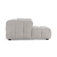 Side view of gray chaise sectional showing its rounded back, low seat and short dark feet