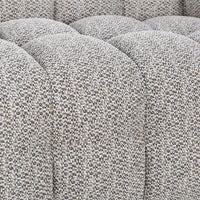 Close-up of gray sectional seat channels and densely textured fabric