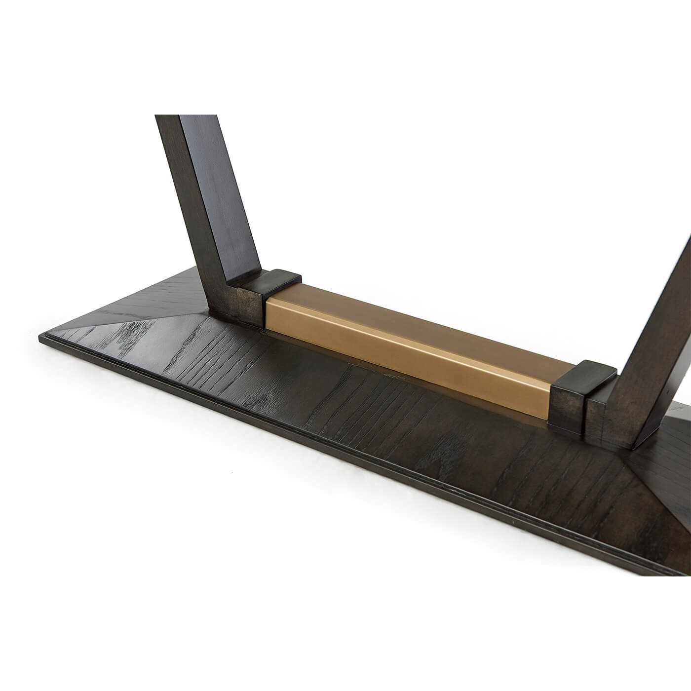 Close-up of console table base and gold accent.