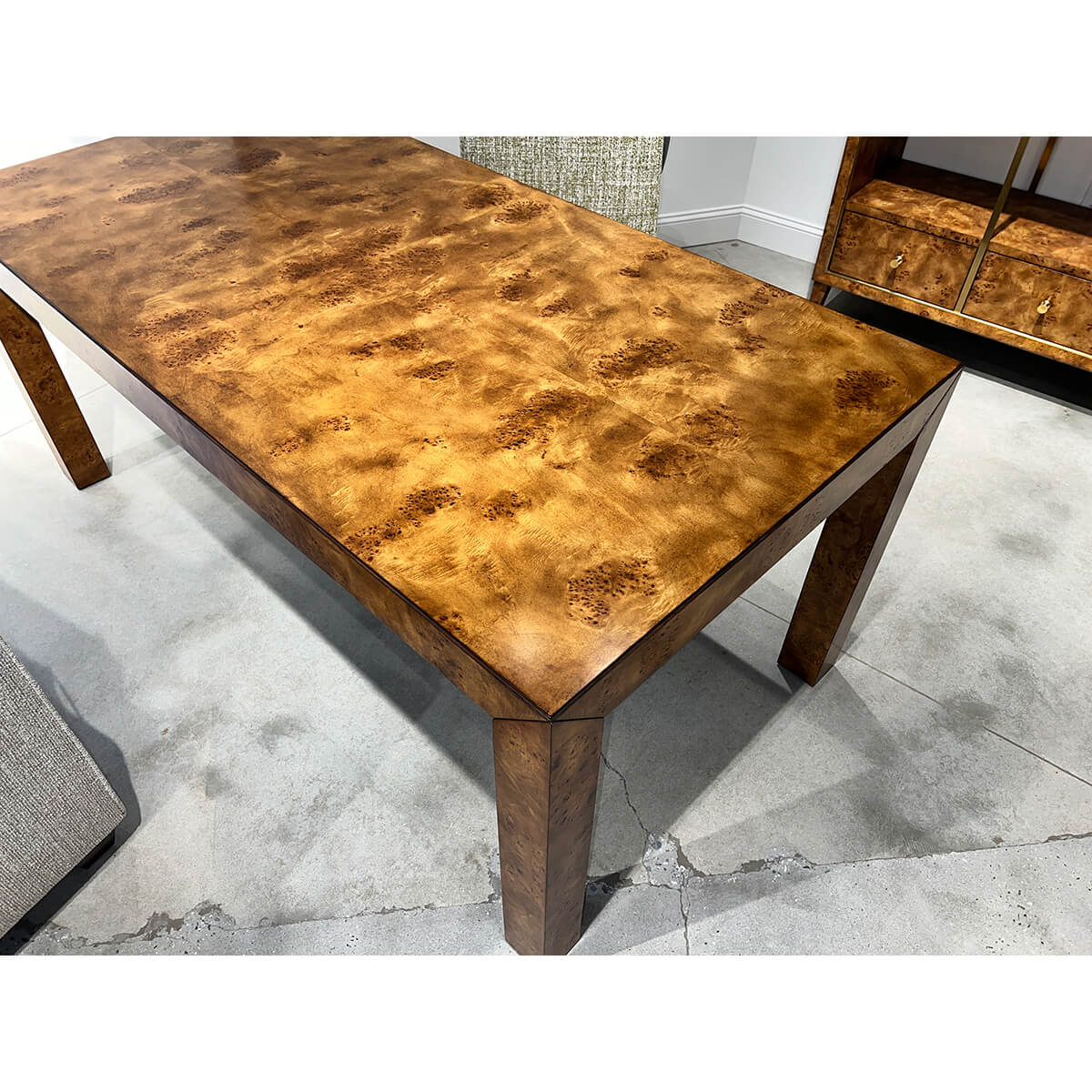 Surface detail of burl wood desk in office.