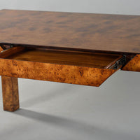 Open drawer of burl wood Parson desk, close-up.