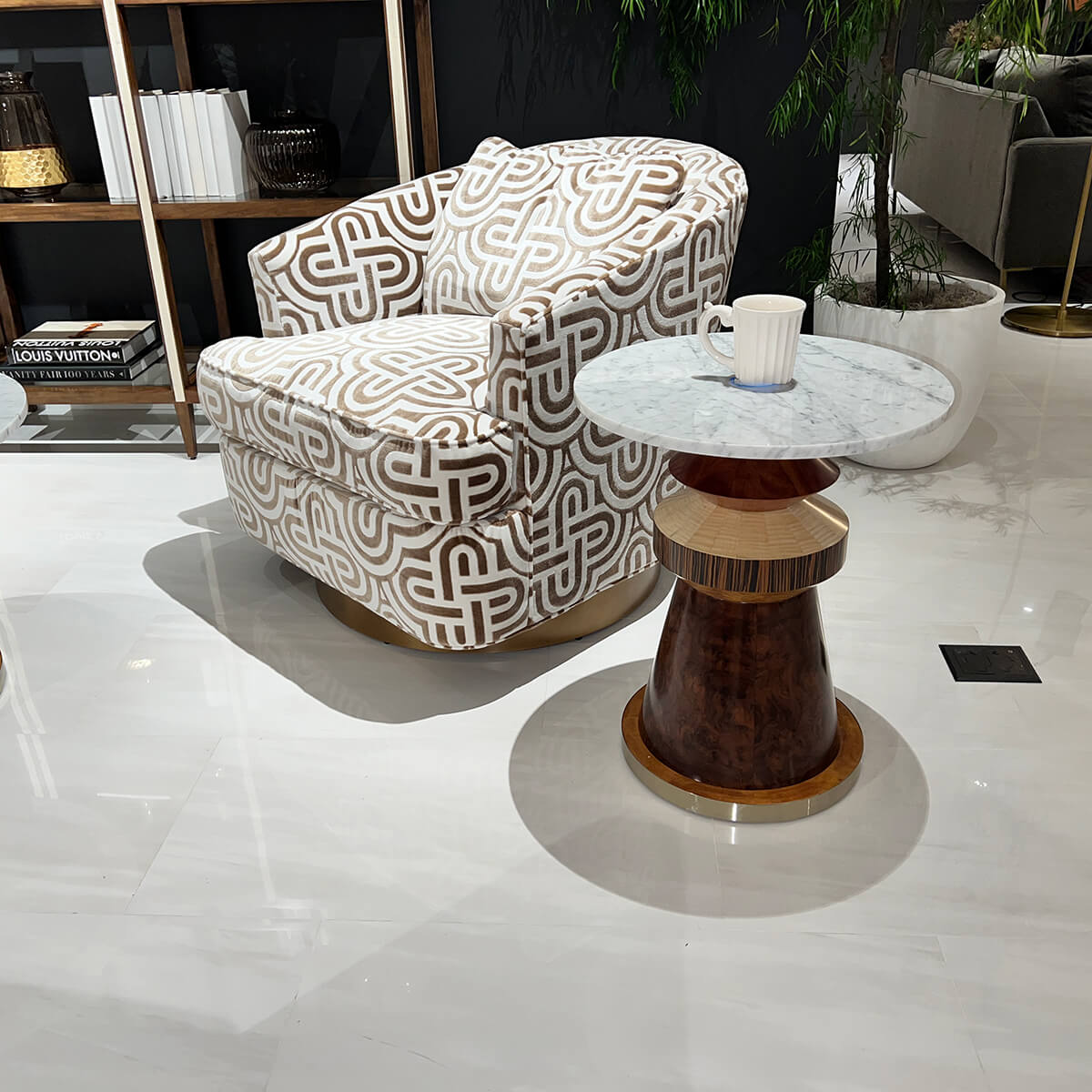 Eclectic accent table beside patterned armchair.