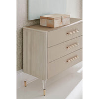 Three-drawer dresser in room corner with decorative box.