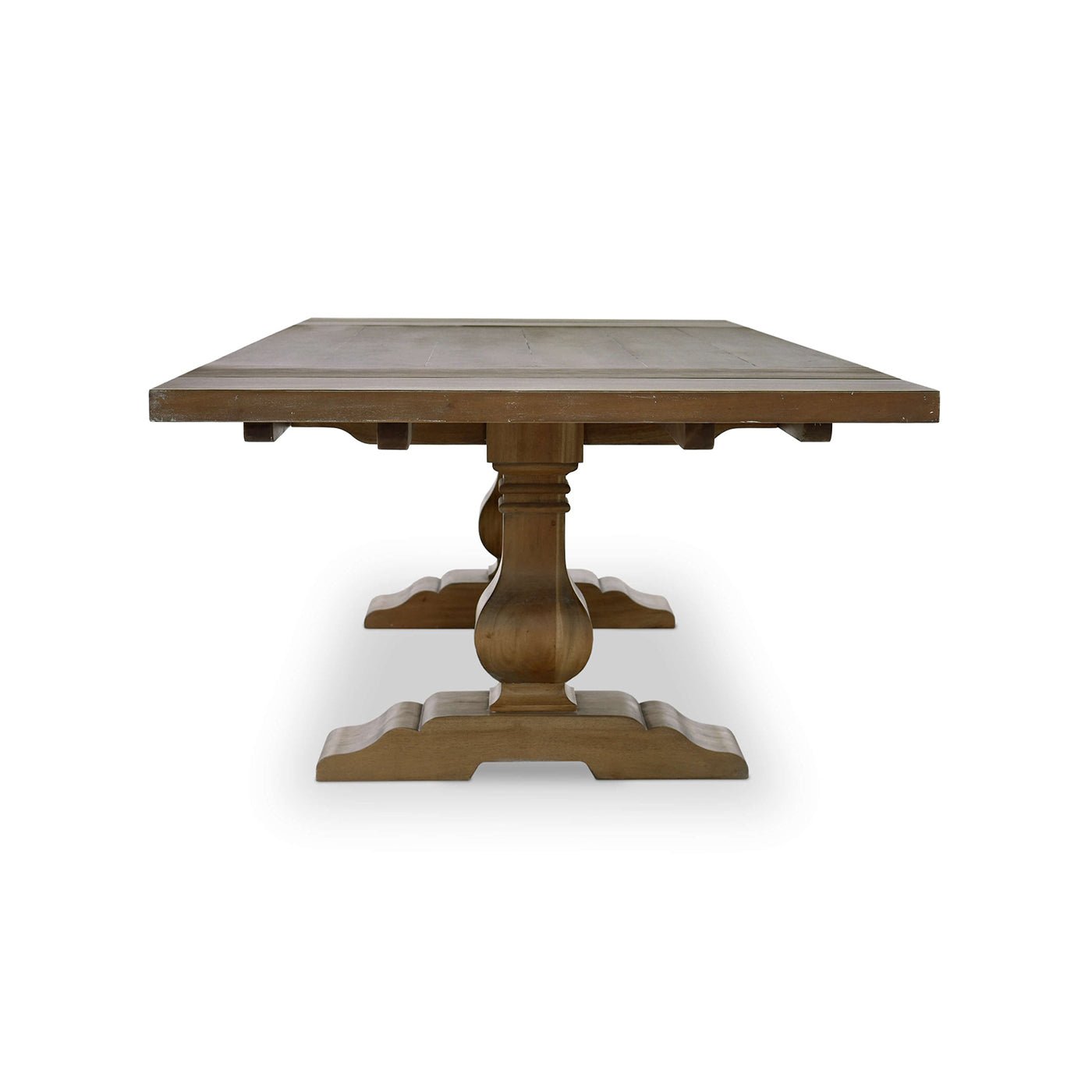 Side view of dining table, highlighting trestle base.