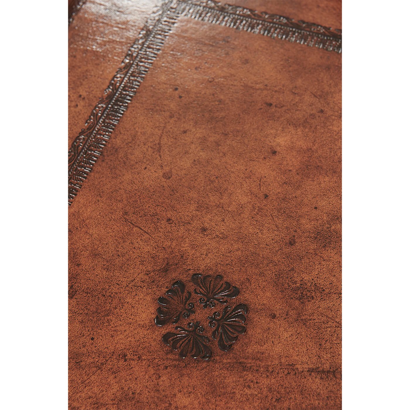 Close-up of intricate pattern on leather serving tray.